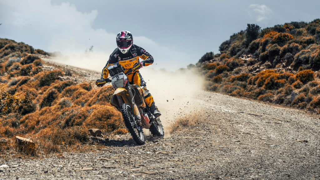 Dynamic Motorcycle Wallpaper: Racer on Rugged Dirt Trail