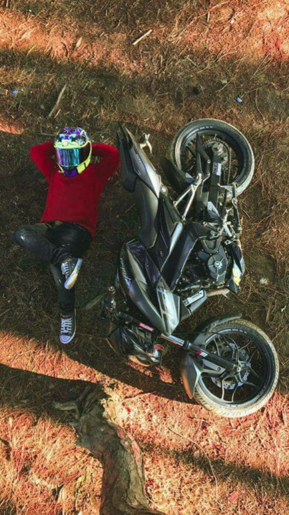 Relaxed Rider by NS 200 Motorcycle: Earthy Tones Wallpaper