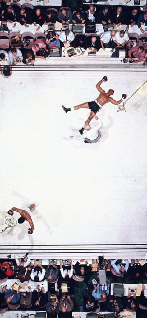 Dynamic Muhammad Ali iPhone Wallpaper: Iconic Boxing Moment Background