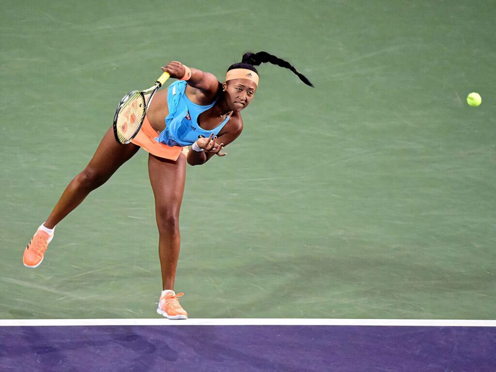 Dynamic Naomi Osaka Tennis Serve Wallpaper - Athleticism & Focus
