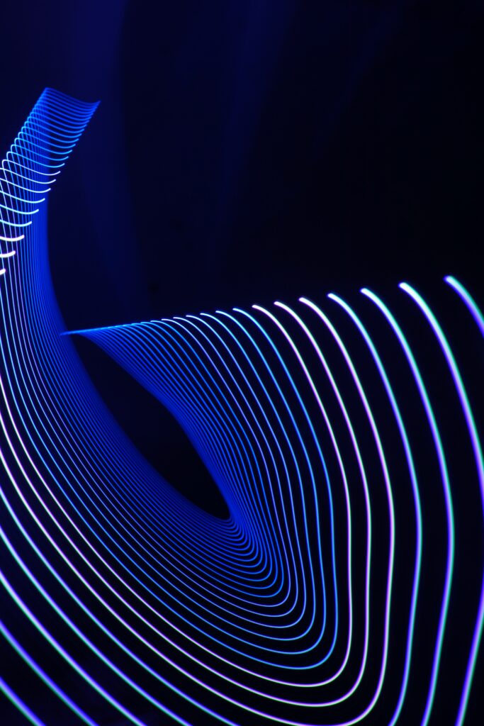 Neon Blue Abstract Wallpaper: Dynamic Wavy Patterns on Dark Background