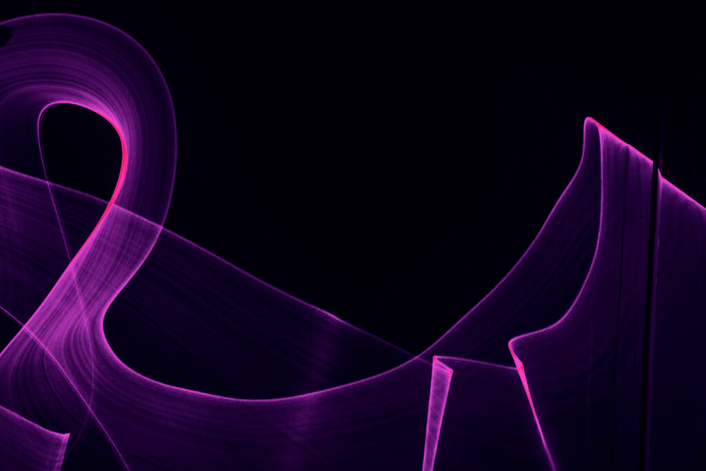 Vibrant Neon Purple Light Trails Wallpaper on Dark Background