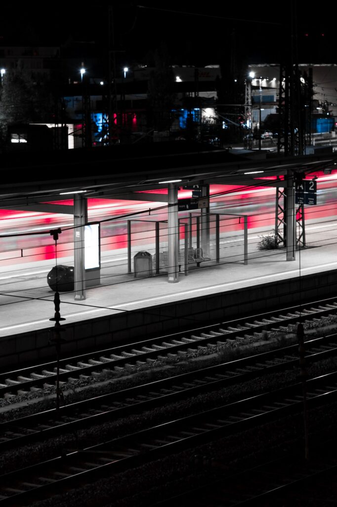 Moody Night Wallpaper: Modern Train Station with Dramatic Backlights
