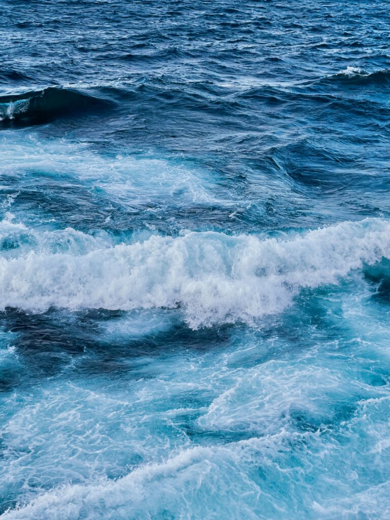 Dynamic ocean wallpaper with vivid blue waves and textured water capturing sea energy