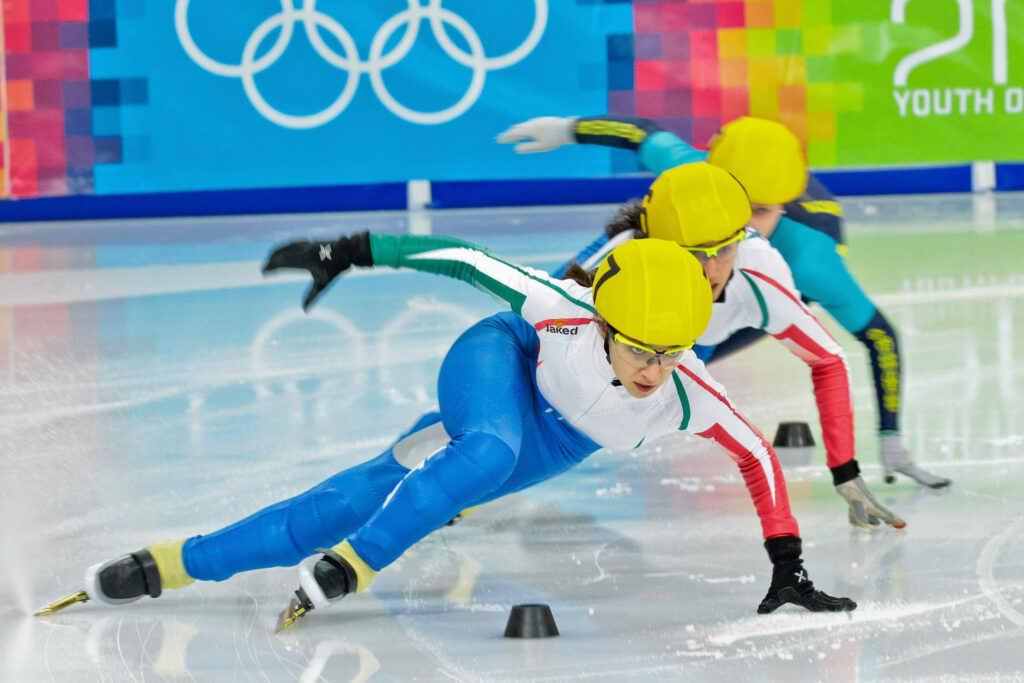 Dynamic Olympic Short Track Speed Skating Wallpaper - Agility & Precision