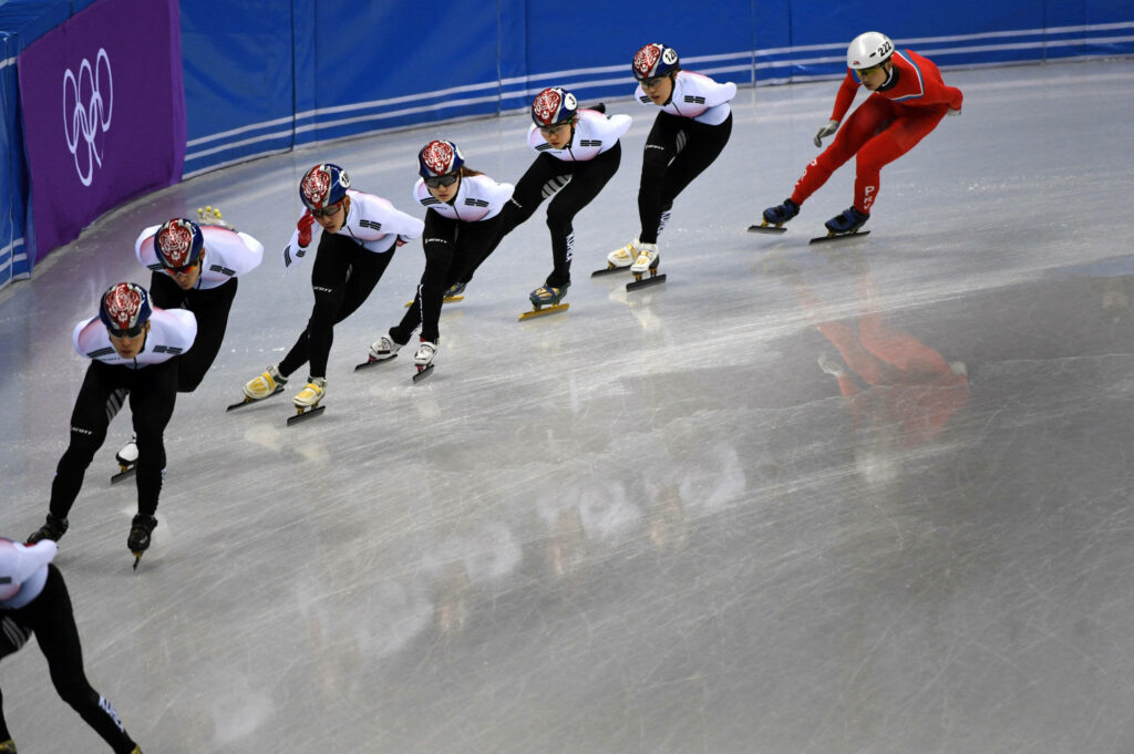 Dynamic Speed Skating Olympics Wallpaper: Athletes in Action