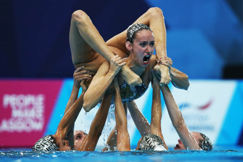 Dynamic Olympic Synchronized Swimming Team Wallpaper - Skill & Strength