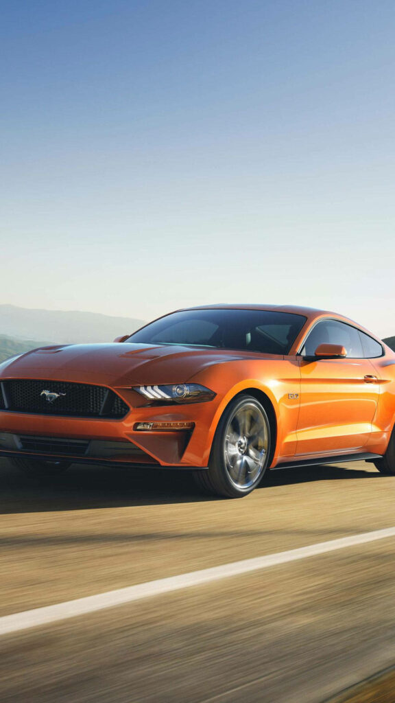 Sleek Orange Ford Mustang Wallpaper: Sunset Sky in Motion