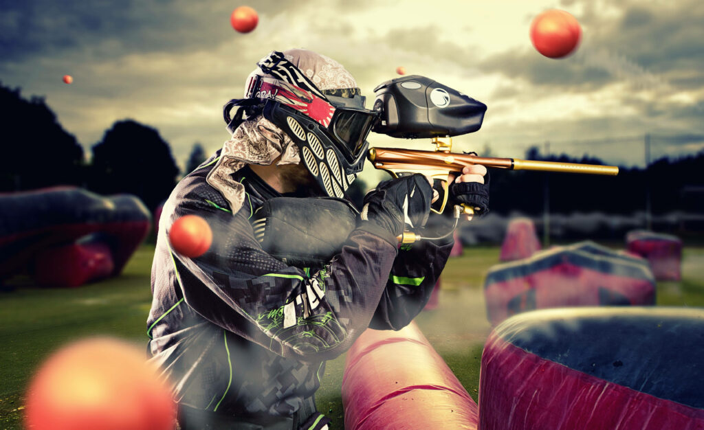 Dynamic Paintball Player Wallpaper: Action-Packed Outdoor Scene