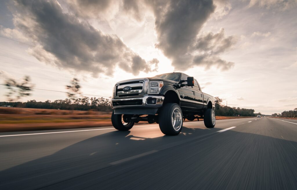 Dynamic Pickup Truck Wallpaper: Adventure on Open Road Under Sky