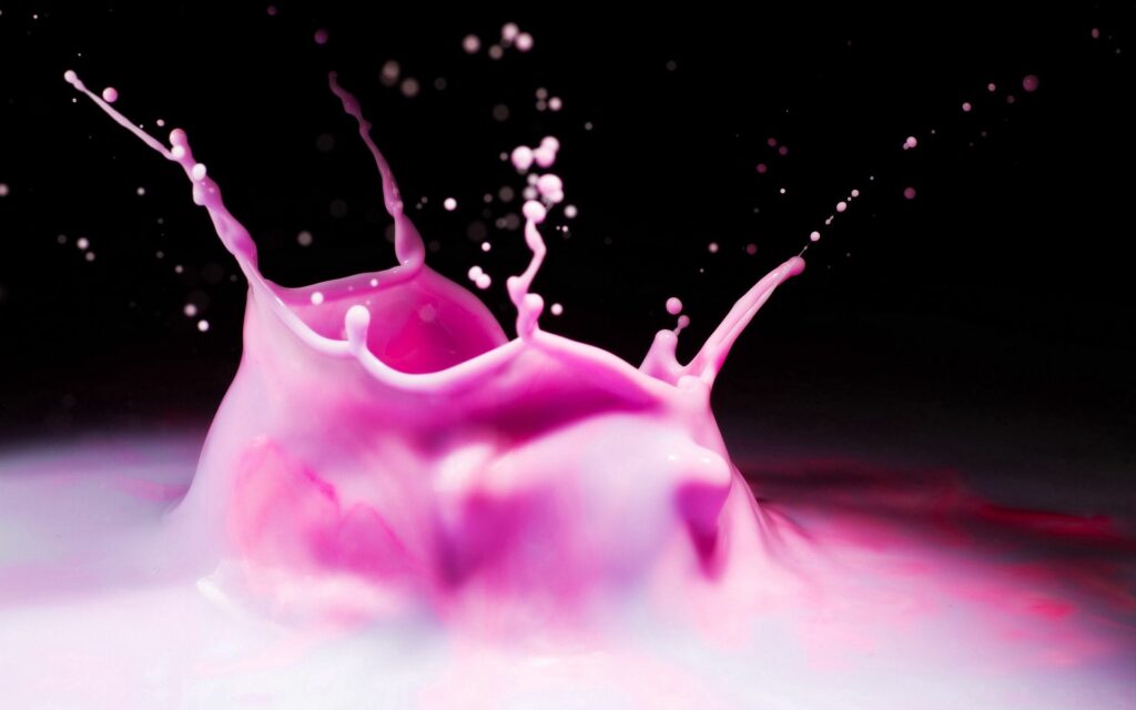Vibrant Pink Liquid Splash Wallpaper Against Dark Background