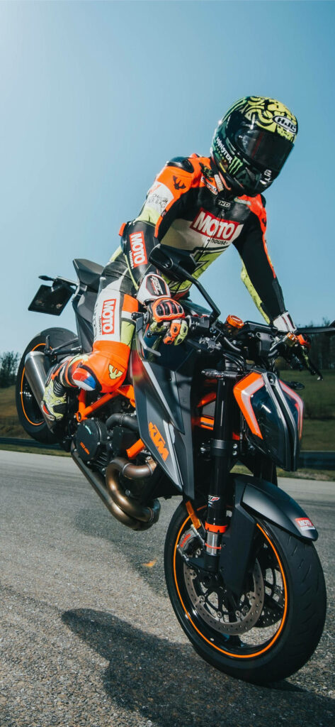 Dynamic Racer Wheelie: Vibrant KTM Motorcycle Wallpaper