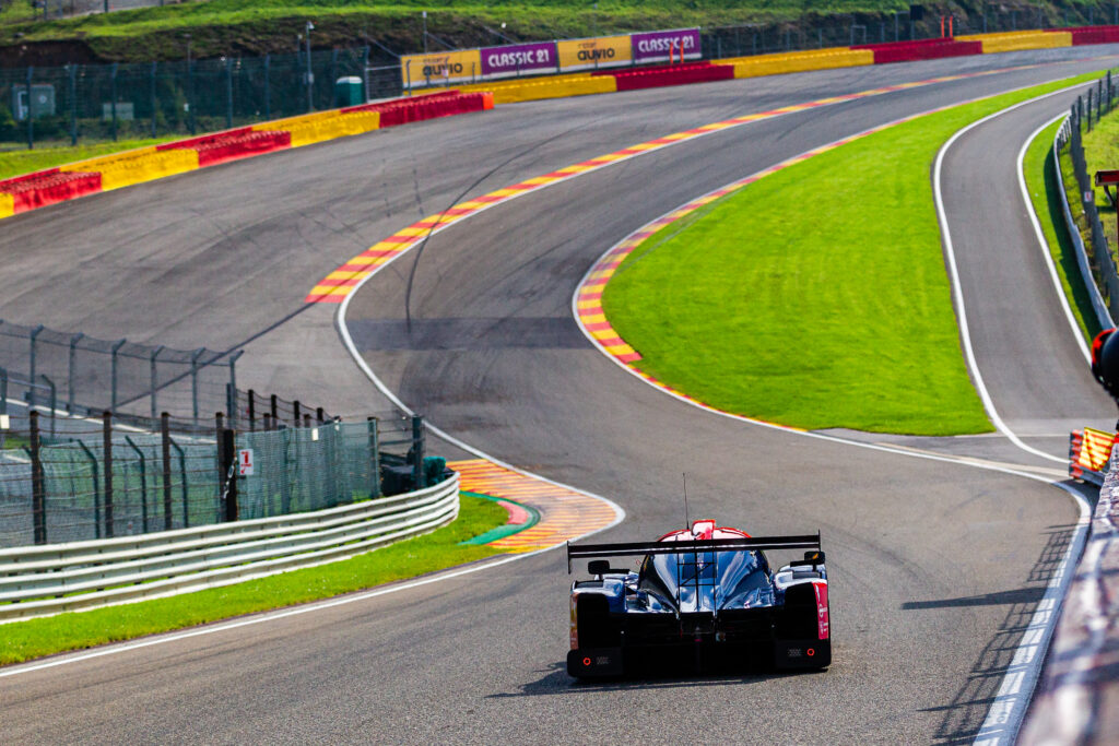 Sleek Car Racing on Vibrant Track - High-Resolution Wallpaper