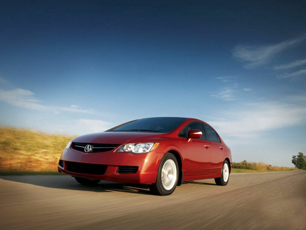 Red Acura CSX Sedan in Motion Against Scenic Background Wallpaper