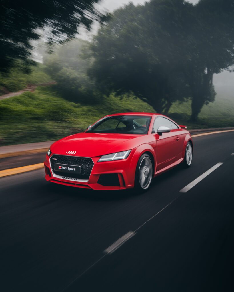 Red Audi TT Sports Car: Dynamic Motion Wallpaper with Greenery