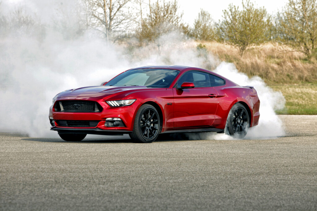 Dynamic Red Ford Mustang GT: Sleek Performance in Action Wallpaper
