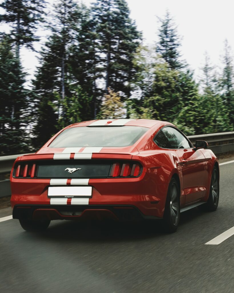 Dynamic Red Ford Mustang Wallpaper: Speed & Performance in Nature