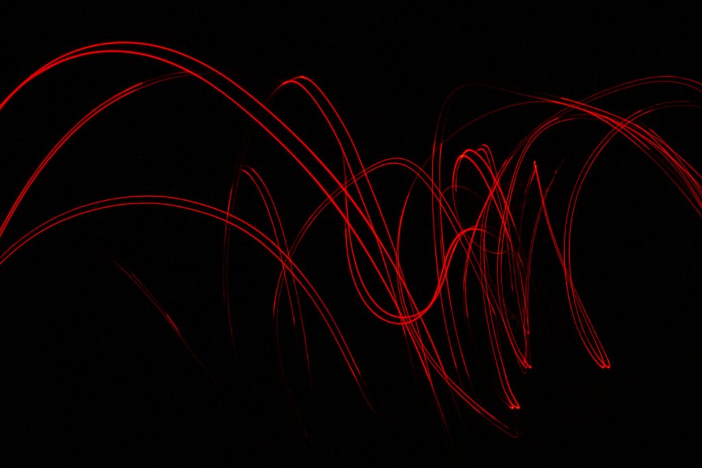 Dynamic Red Light Trails on Black Background - Abstract Wallpaper