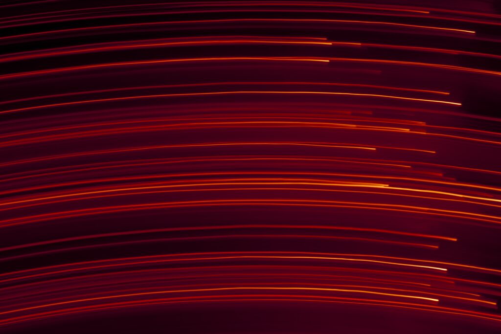 Dynamic Red Light Wallpaper with Fluid Motion Blur Background
