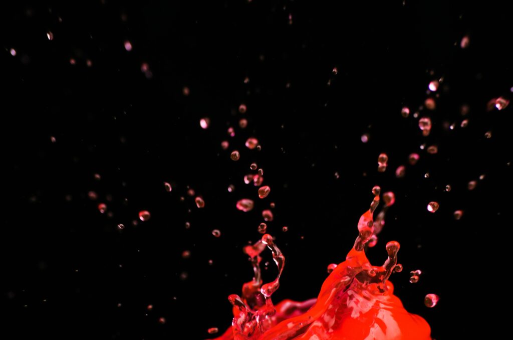 Dynamic Red Liquid Splash Wallpaper on Black Background