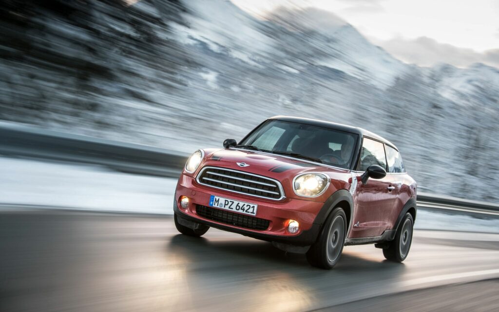 Red Mini Cooper Dynamic Wallpaper: Sleek Car in Motion, Snowy Mountains