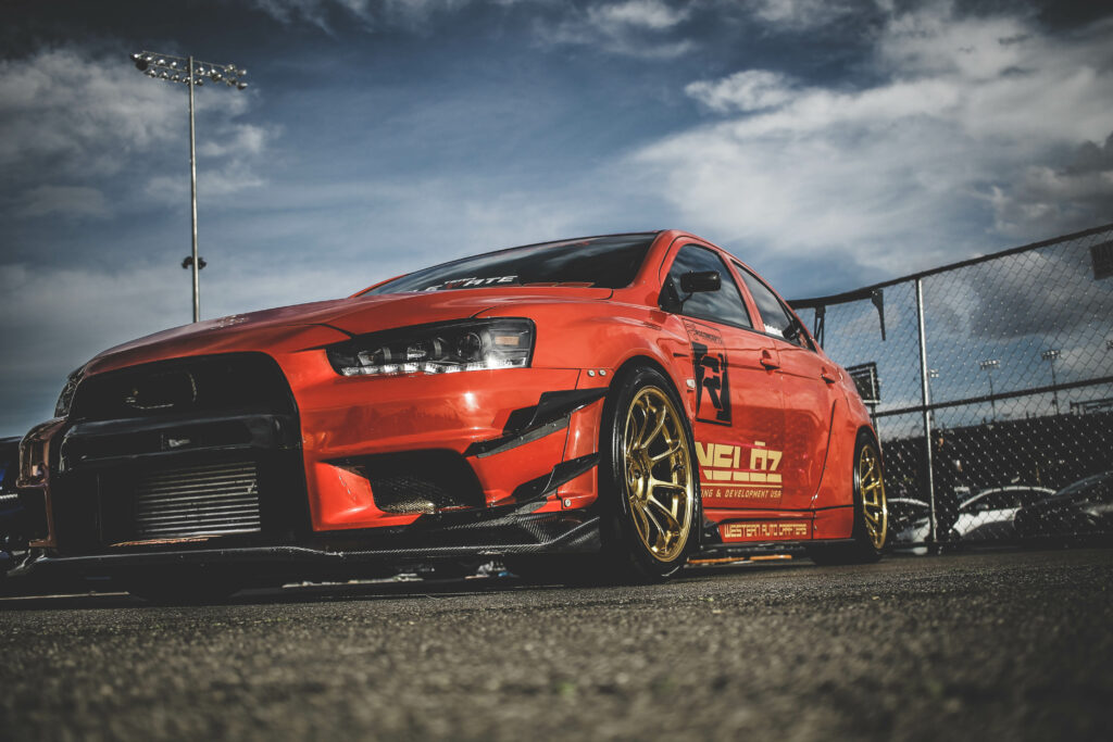 Dynamic Red Mitsubishi Lancer Evo X with Gold Rims - Sports Car Wallpaper