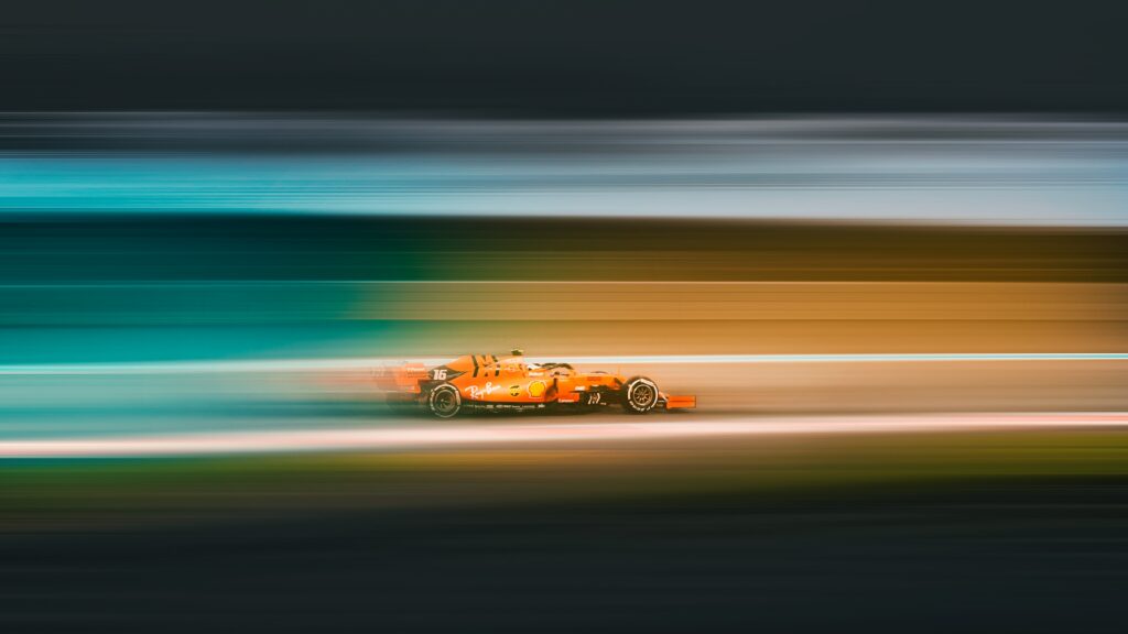 Dynamic Red Race Car Wallpaper: Speed & Motion for Racing Fans