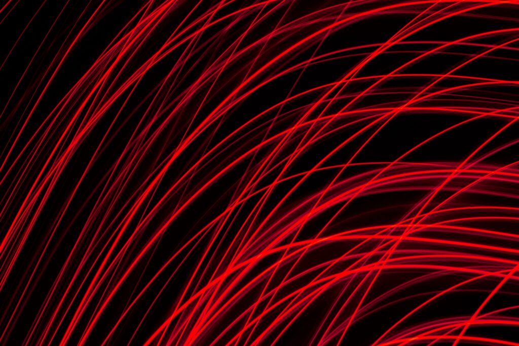 Dynamic Red Stripes Wallpaper: Energetic Curves on Dark Background