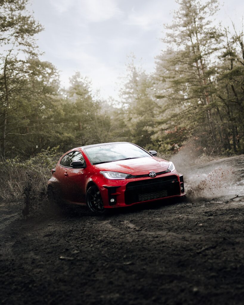 Dynamic Red Toyota Wallpaper: Adventure in the Forest