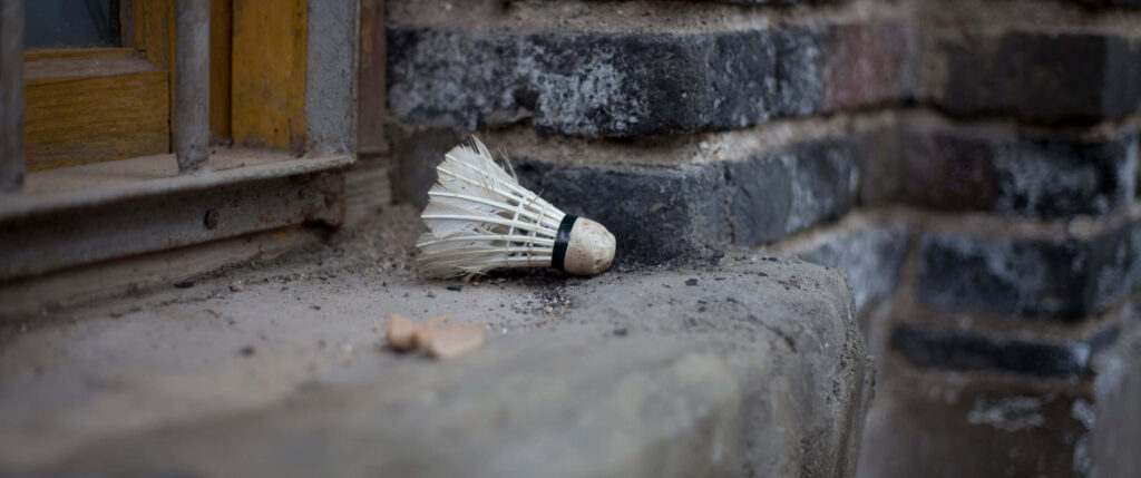 Badminton Shuttlecock Near Stone Wall Background Wallpaper