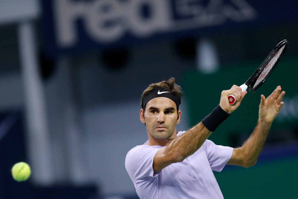 Dynamic Roger Federer Wallpaper: Powerful Tennis Swing Background