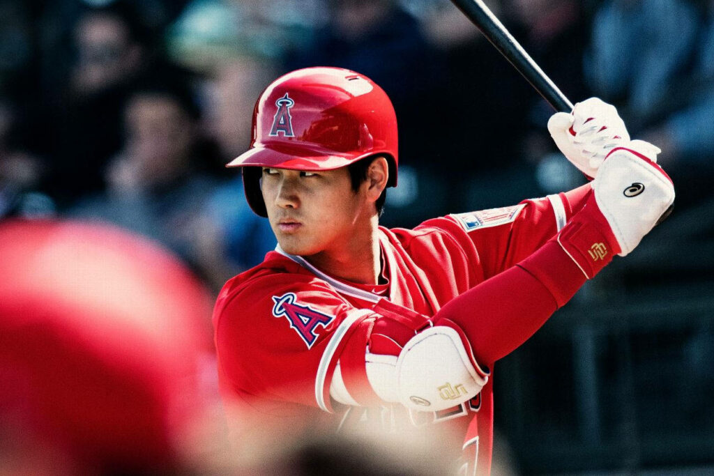 Vibrant Shohei Ohtani Batting Wallpaper in Team Red Uniform