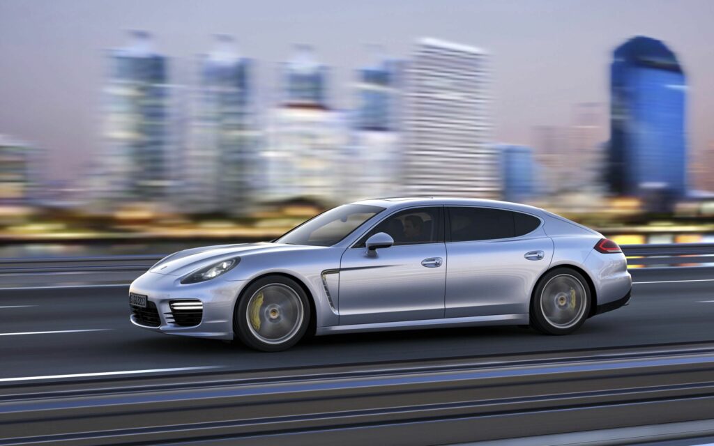 Silver Porsche Panamera in Motion: Dynamic Cityscape Wallpaper