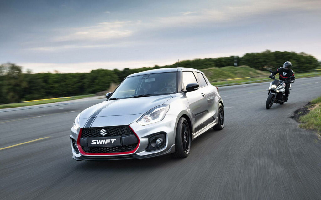 Dynamic Suzuki Swift Wallpaper: Speed and Agility on Serene Roads