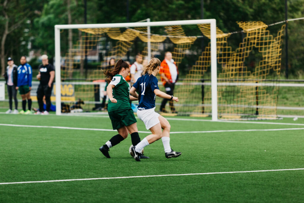 Dynamic Soccer Wallpaper: Teamwork & Determination on Lush Field