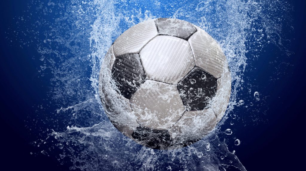 Textured soccer ball splashing water on vibrant blue background high quality football wallpaper