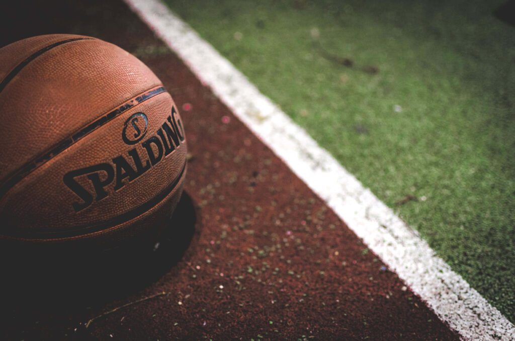 Dynamic Spalding Basketball Wallpaper with Textured Court Background