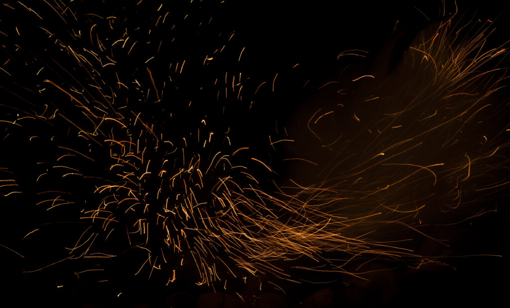 Mesmerizing Abstract Wallpaper: Dynamic Sparks on Dark Background