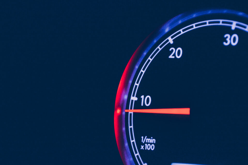 Dynamic Speedometer Wallpaper: Close-Up with Red Arrow Contrast
