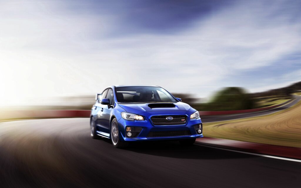 Blue Subaru WRX STI Racing Wallpaper: Speed on a Winding Track