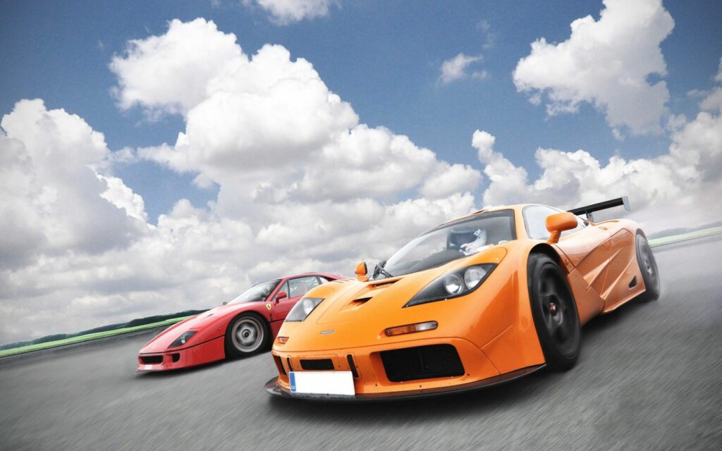 Dynamic 1680x1050 Supercars Racing Wallpaper Under Vibrant Sky
