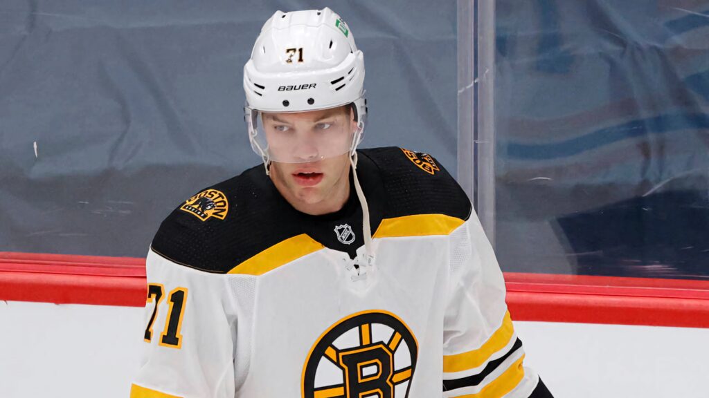 Taylor Hall Boston Bruins NHL player close-up action shot in white gold hockey jersey wallpaper