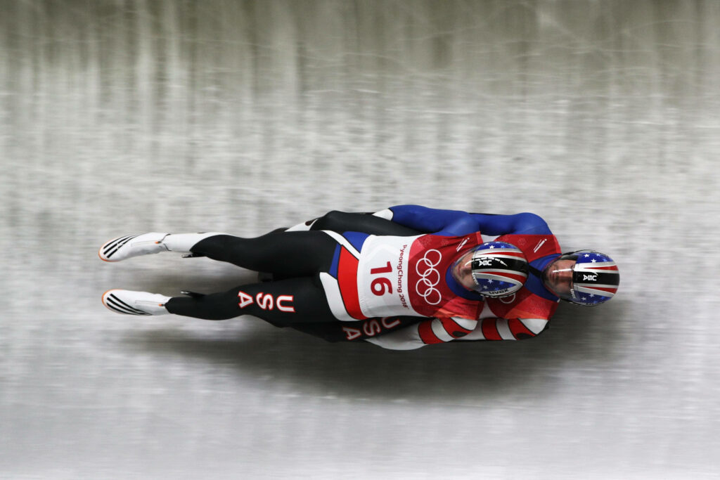 Dynamic Team USA Luge Athletes Wallpaper: Speed & Teamwork in Action
