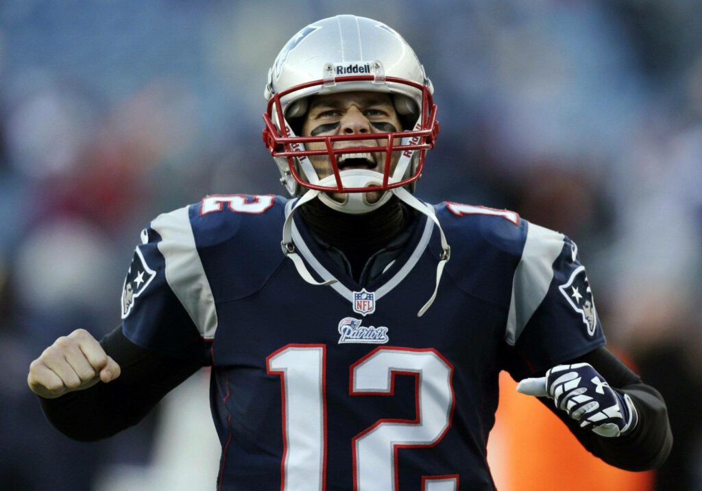 Dynamic Tom Brady Wallpaper: Energetic Football Moment with Face Paint
