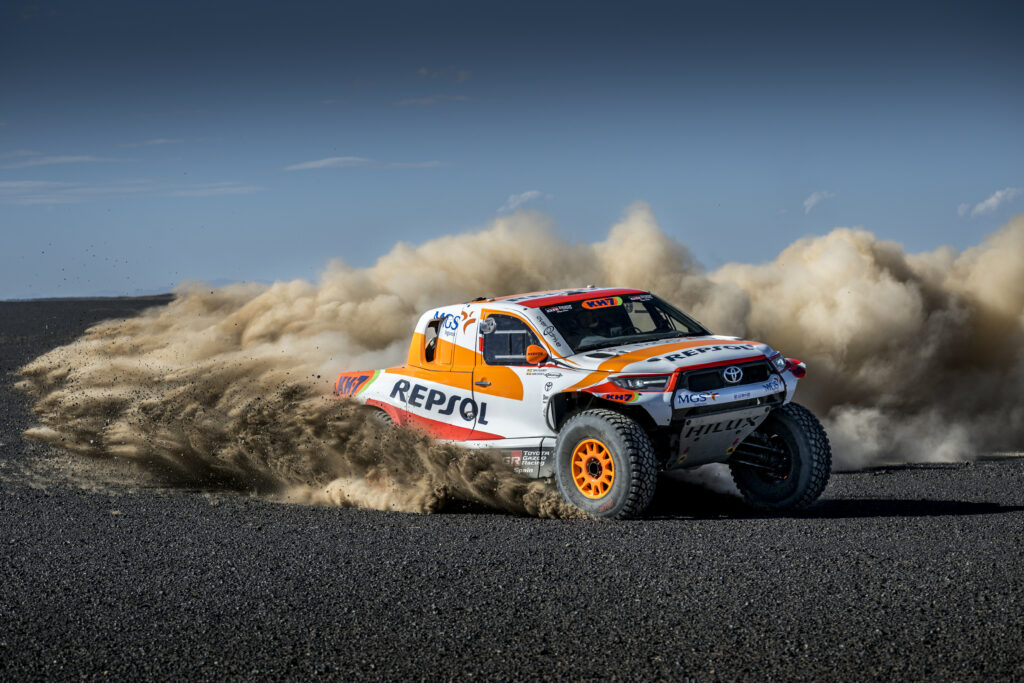Dynamic Toyota Hilux Rally Car Wallpaper with Dusty Action Scene