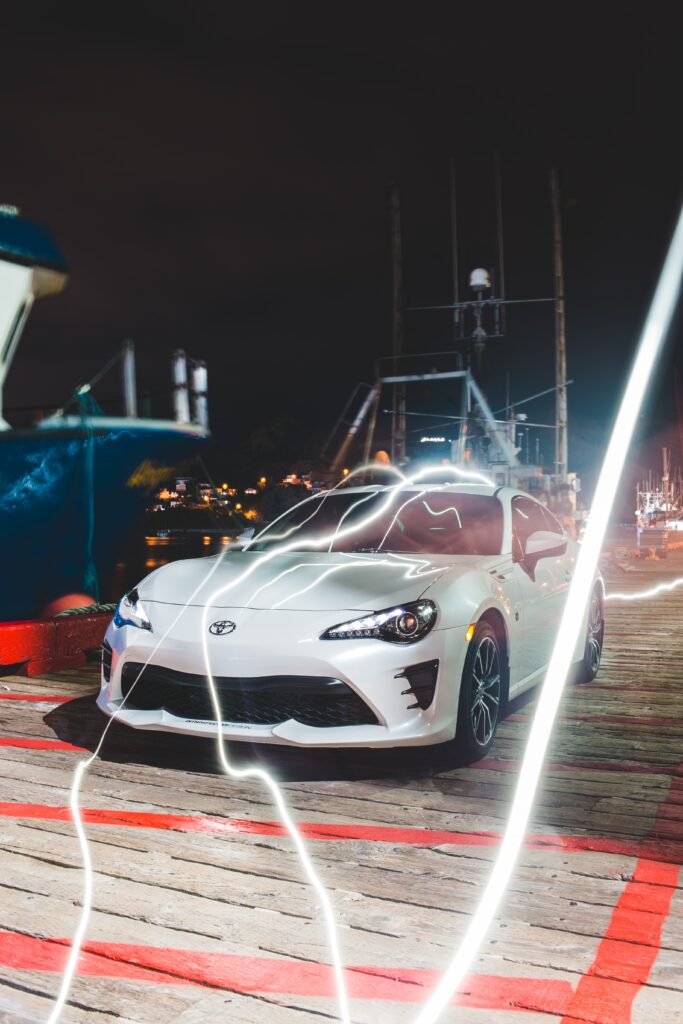 Electrifying Toyota Sports Car Wallpaper: Nighttime Dock Scene