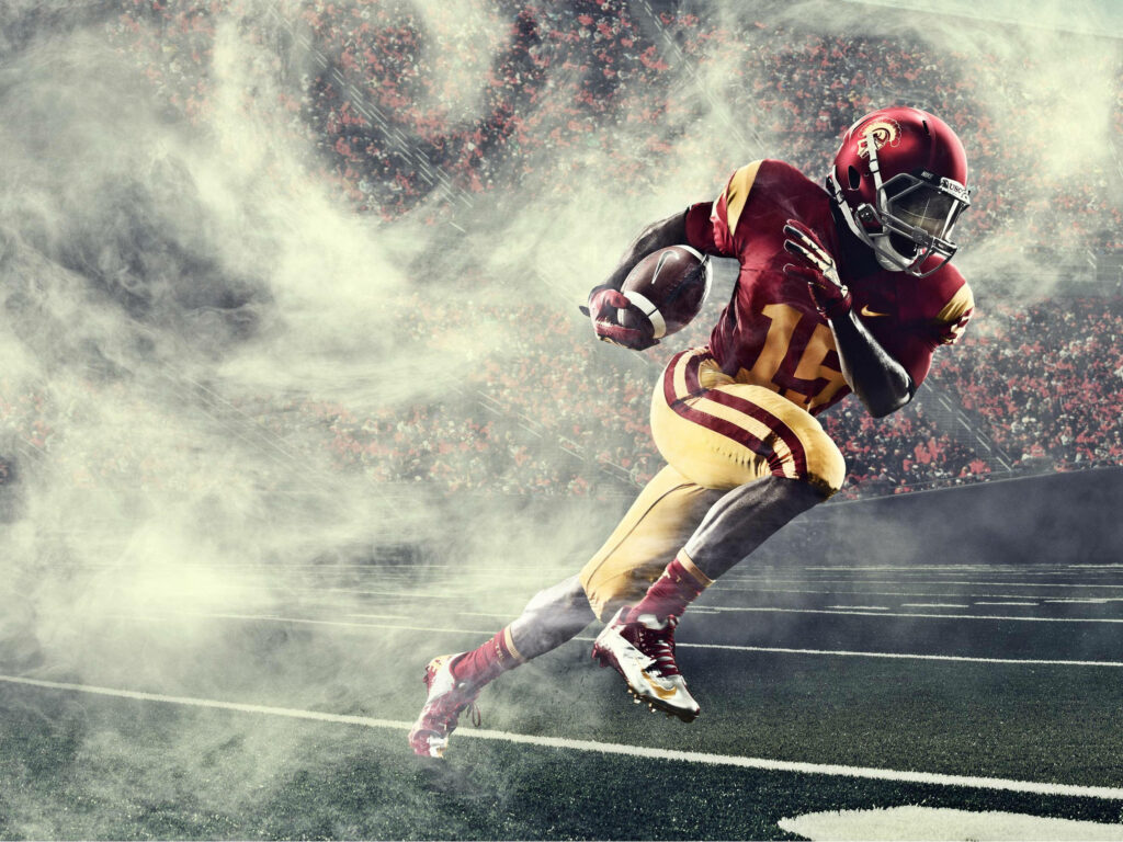 Dynamic USC Football Wallpaper: Player in Action with Smoke & Stadium