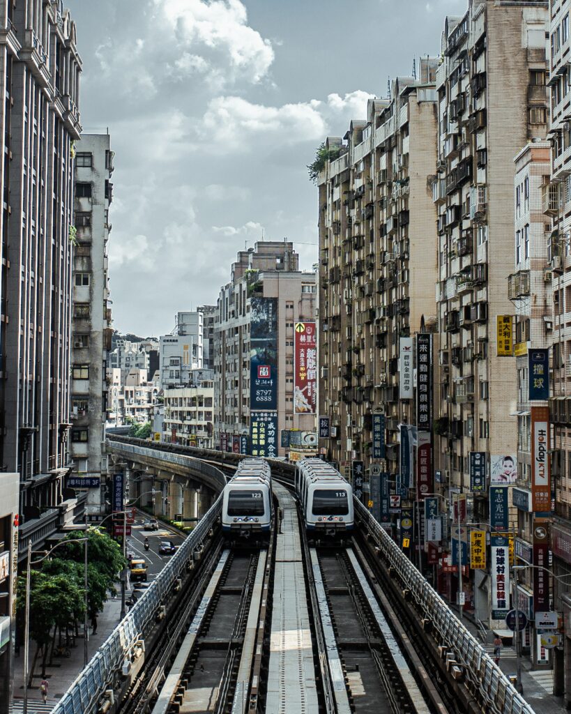 Dynamic Urban Wallpaper: Modern Trains on Elevated Tracks