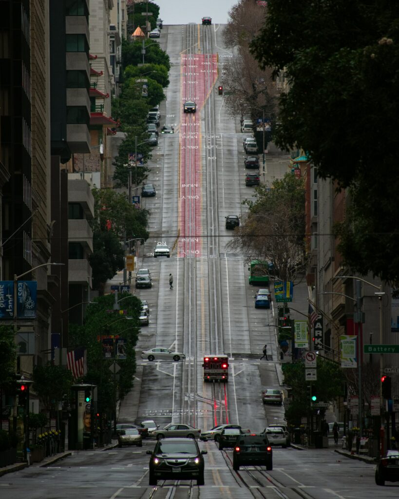 Urban Hilly Street Wallpaper: Dynamic Cityscape with Architecture & Trees