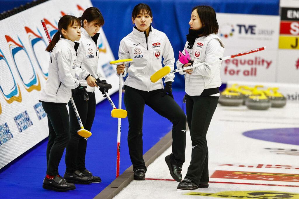 Dynamic Wallpaper: Female Curling Team in Action on Ice